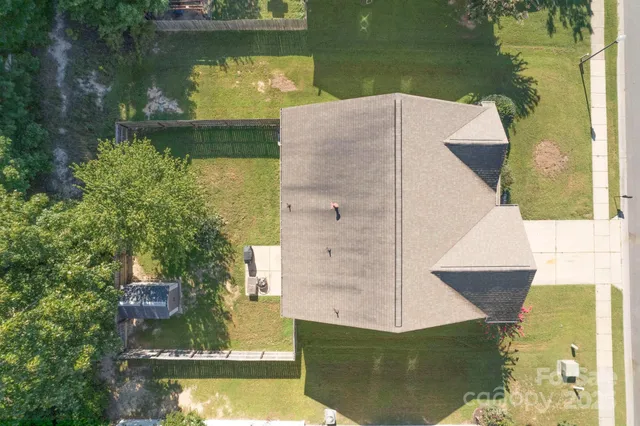 an aerial view of a house with a lake view