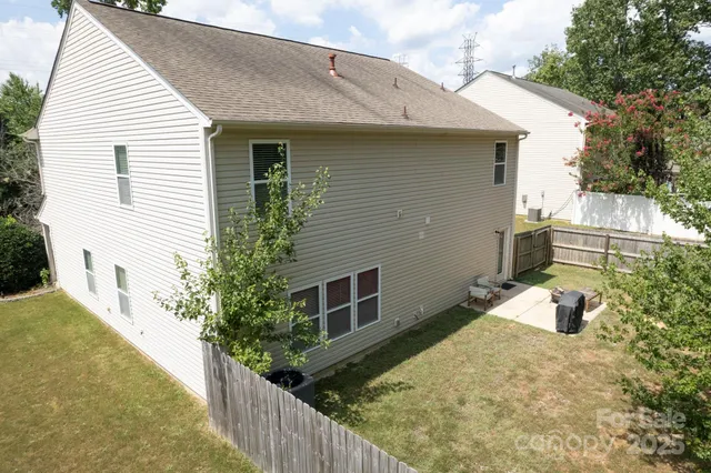 a view of a house with wooden fence