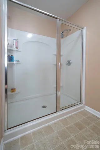 a bathroom with a glass shower door