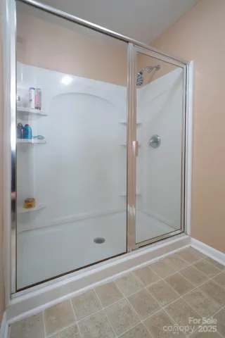 a bathroom with a glass shower door