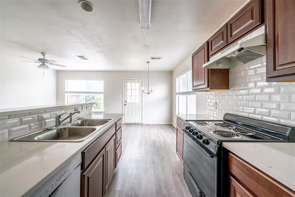 9927 Bilbrook Place, Unit B Austin, TX 78748 - Photo 2 of 13 Kitchen featuring black electric range, tasteful backsplash, dishwasher, and light wood-type flooring