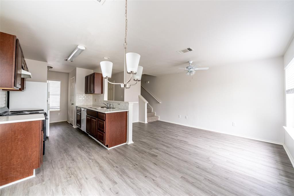 9927 Bilbrook Place, Unit B Austin, TX 78748 - Photo 13 of 13 Kitchen featuring light countertops, range with electric cooktop, hanging lights, backsplash, and open floor plan
