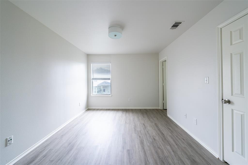9927 Bilbrook Place, Unit B Austin, TX 78748 - Photo 7 of 13 Spare room with wood finished floors and baseboards