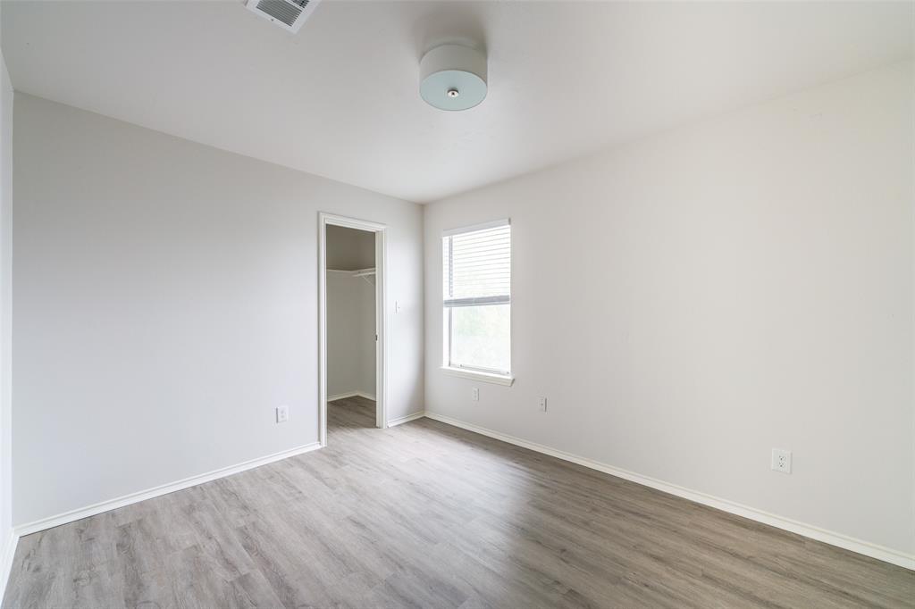 9927 Bilbrook Place, Unit B Austin, TX 78748 - Photo 8 of 13 Unfurnished bedroom with a spacious closet and wood finished floors