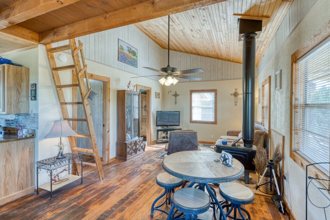 509 Pinon Loop East Camp Wood, TX 78833 - Photo 8 of 24 a dining room with wooden floor a chandelier a glass table and chairs