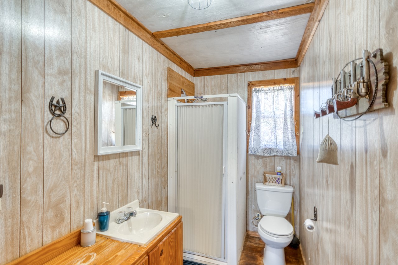 509 Pinon Loop East Camp Wood, TX 78833 - Photo 11 of 24 a bathroom with a sink a toilet and shower curtain