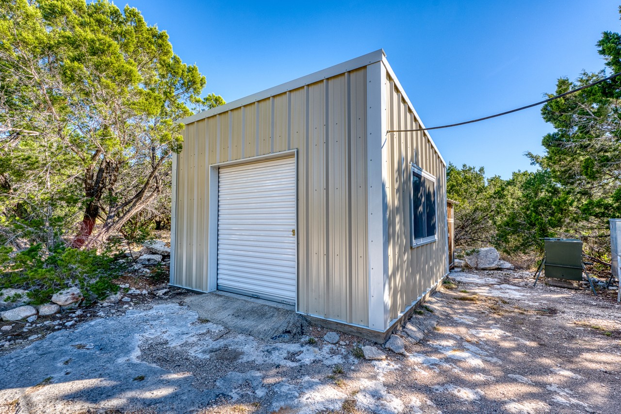 509 Pinon Loop East Camp Wood, TX 78833 - Photo 14 of 24 a view of a house with backyard and sitting area