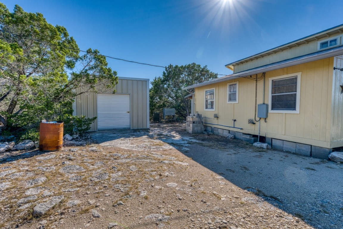 509 Pinon Loop East Camp Wood, TX 78833 - Photo 15 of 24 a view of a house with backyard and sitting area
