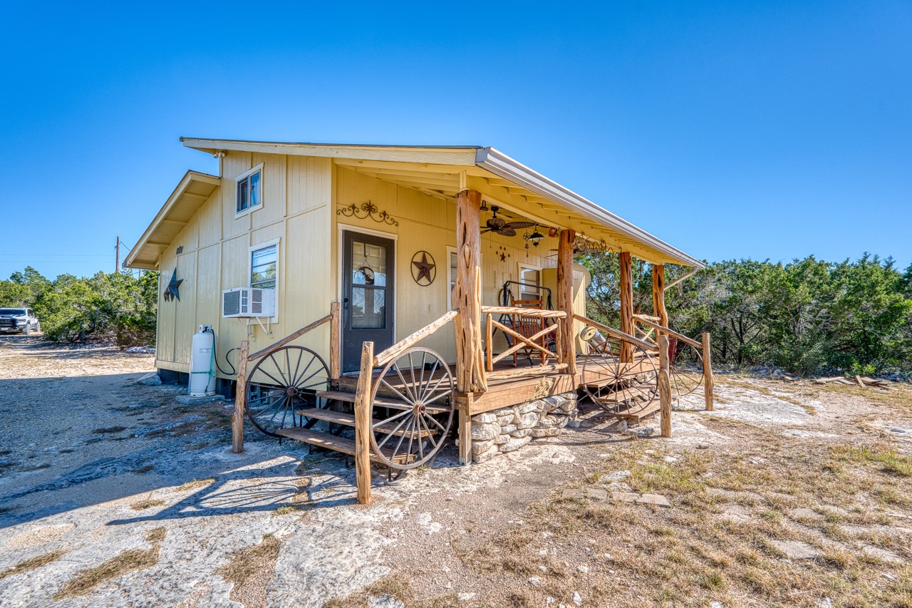 509 Pinon Loop East Camp Wood, TX 78833 - Photo 5 of 24 a view of a house with yard and sitting area