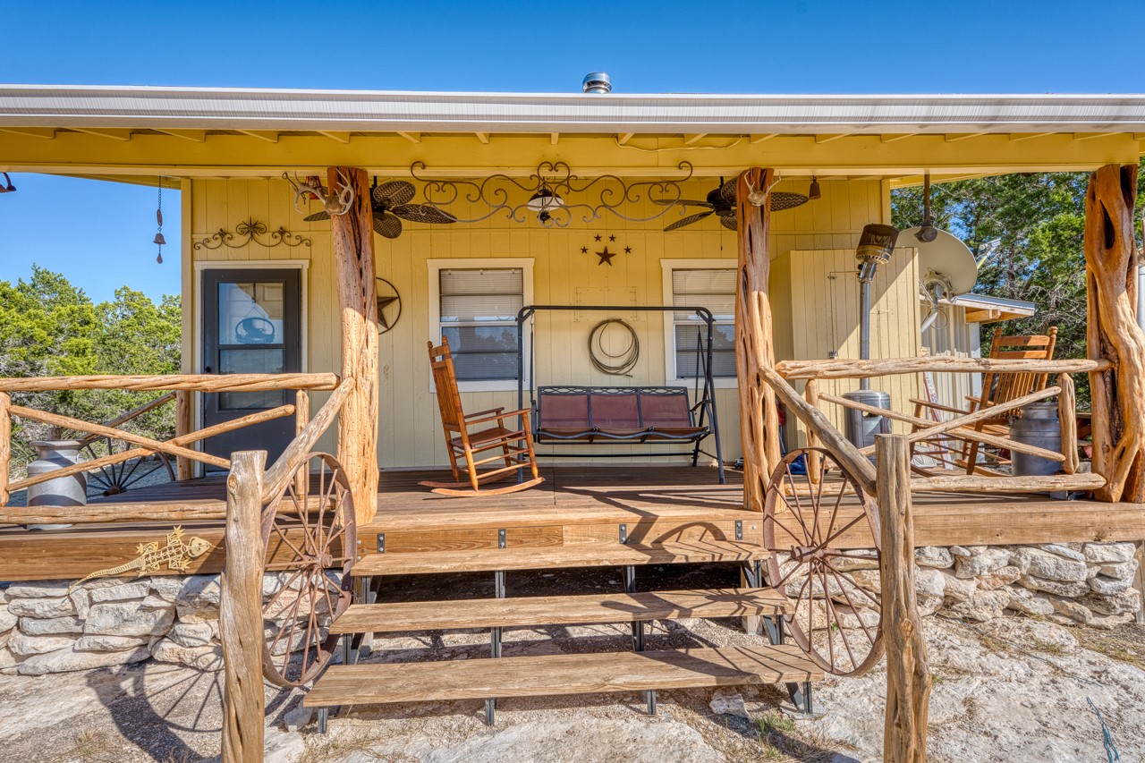 509 Pinon Loop East Camp Wood, TX 78833 - Photo 7 of 24 a view of a balcony with table and chairs