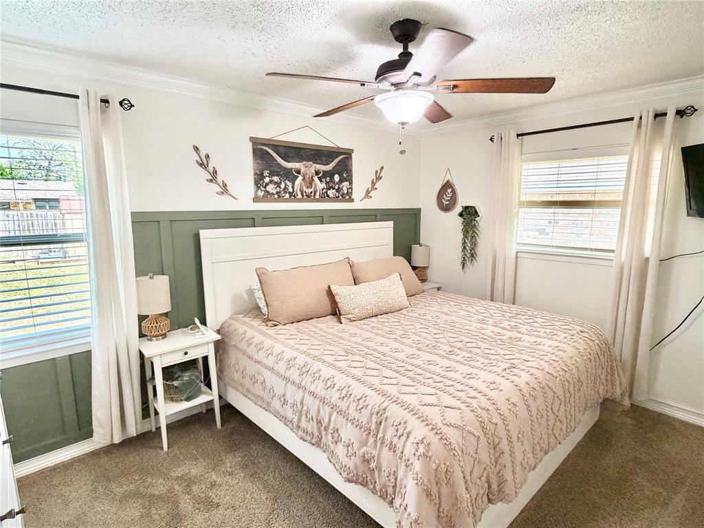 806 Glen Key Street Denison, TX 75020 - Photo 12 of 27 a bedroom with a bed and a window