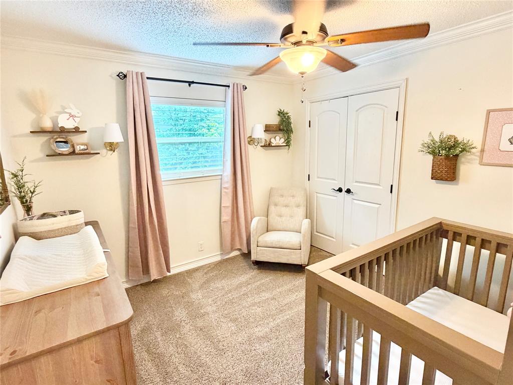 806 Glen Key Street Denison, TX 75020 - Photo 14 of 27 a view of a bedroom with furniture and a window