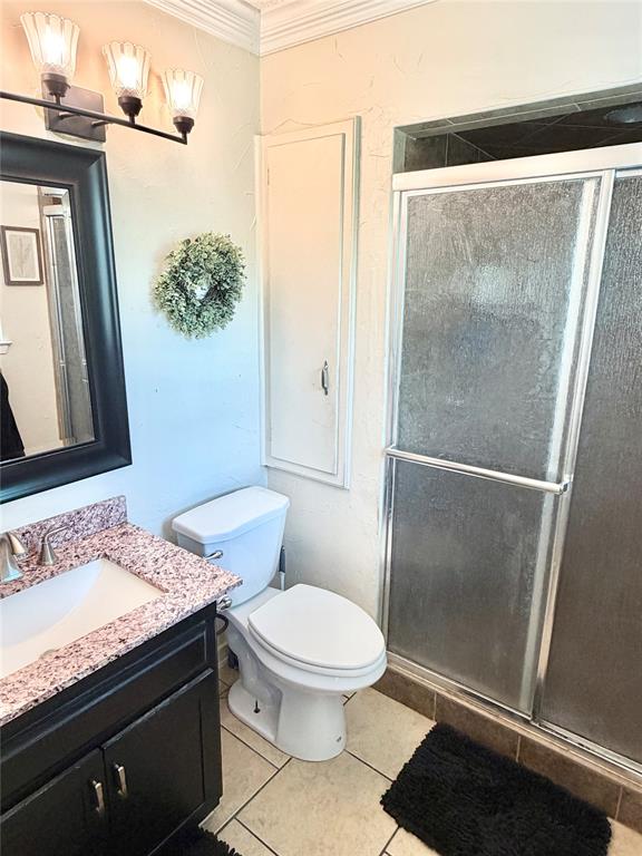 806 Glen Key Street Denison, TX 75020 - Photo 16 of 27 a bathroom with a granite countertop sink toilet and shower