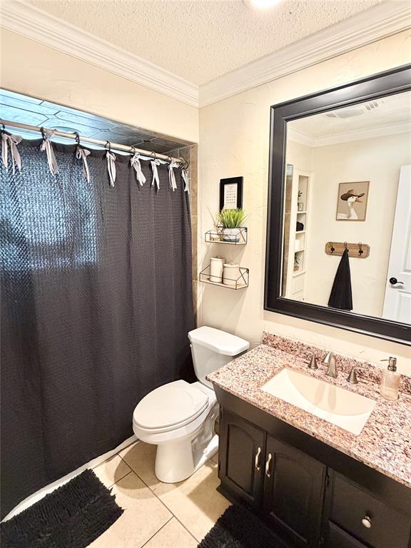 806 Glen Key Street Denison, TX 75020 - Photo 17 of 27 a bathroom with a granite countertop sink toilet and shower