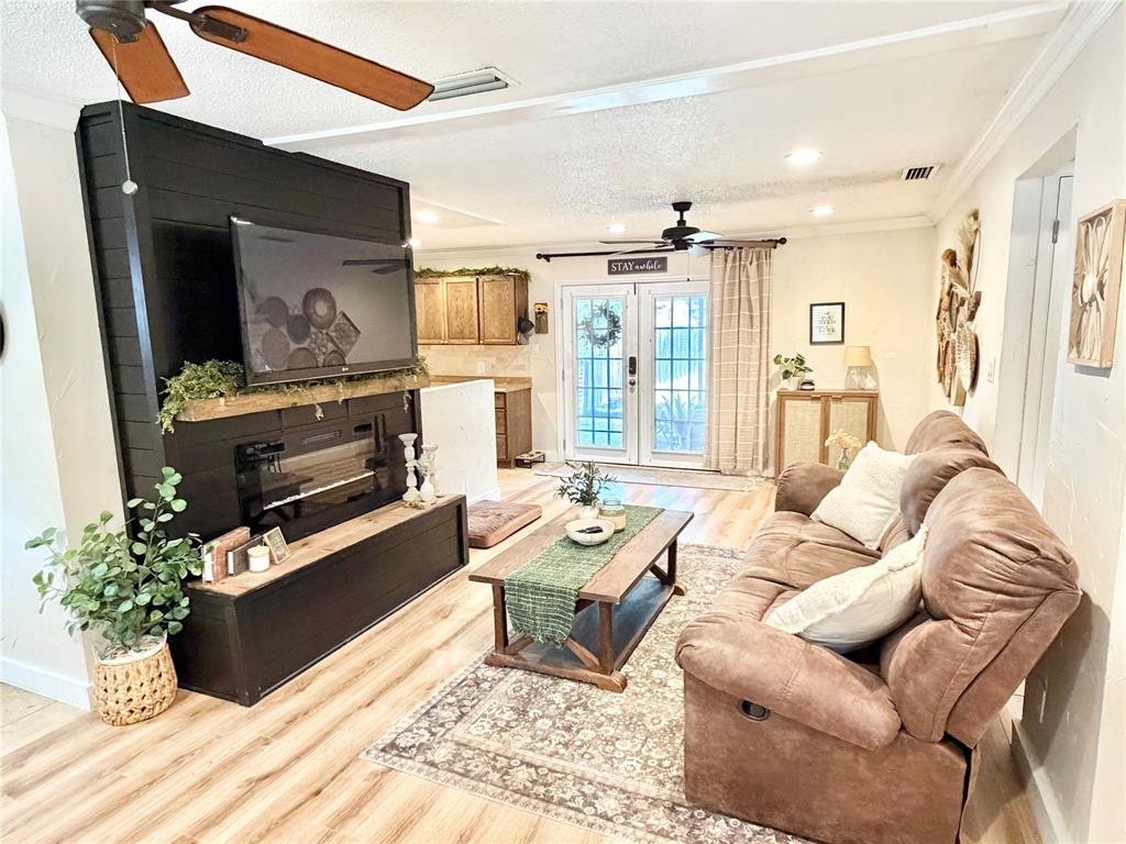 806 Glen Key Street Denison, TX 75020 - Photo 2 of 27 a living room with furniture fireplace and a flat screen tv
