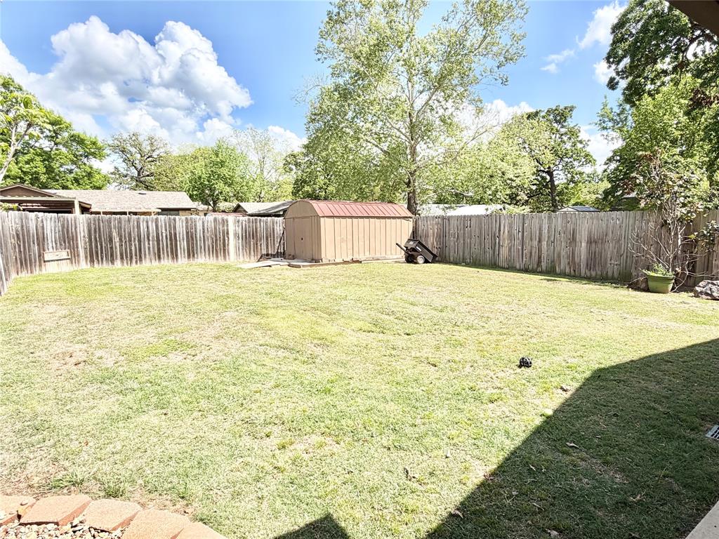 806 Glen Key Street Denison, TX 75020 - Photo 21 of 27 a swimming pool with yard and wooden fence