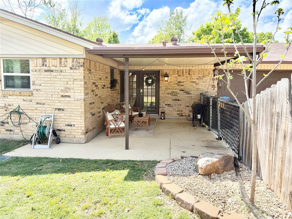 806 Glen Key Street Denison, TX 75020 - Photo 23 of 27 a view of a patio with table and chairs and potted plants