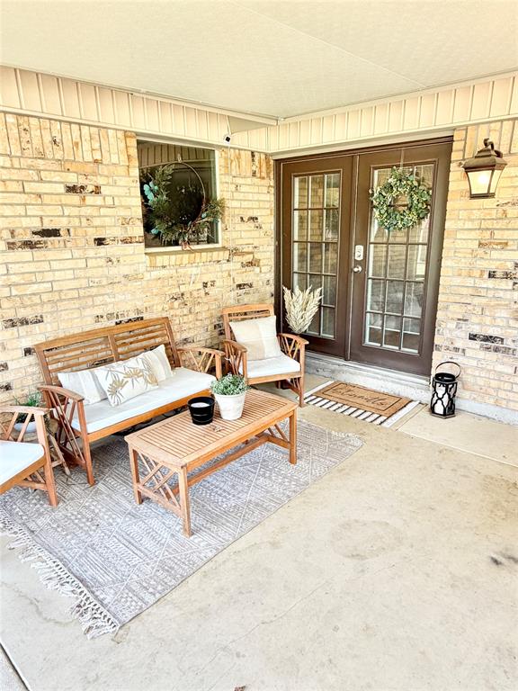 806 Glen Key Street Denison, TX 75020 - Photo 24 of 27 a living room with furniture and a flat screen tv