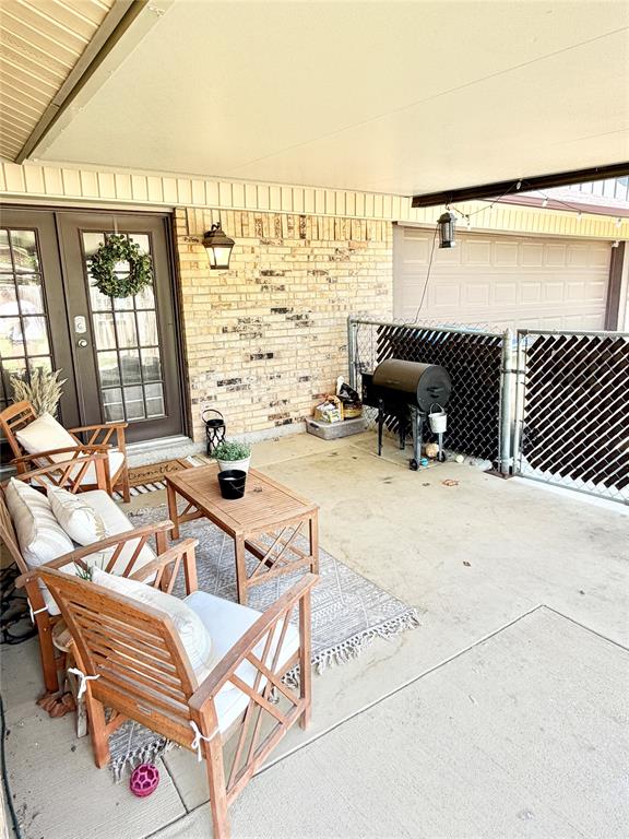 806 Glen Key Street Denison, TX 75020 - Photo 25 of 27 a view of a patio with a table and chairs