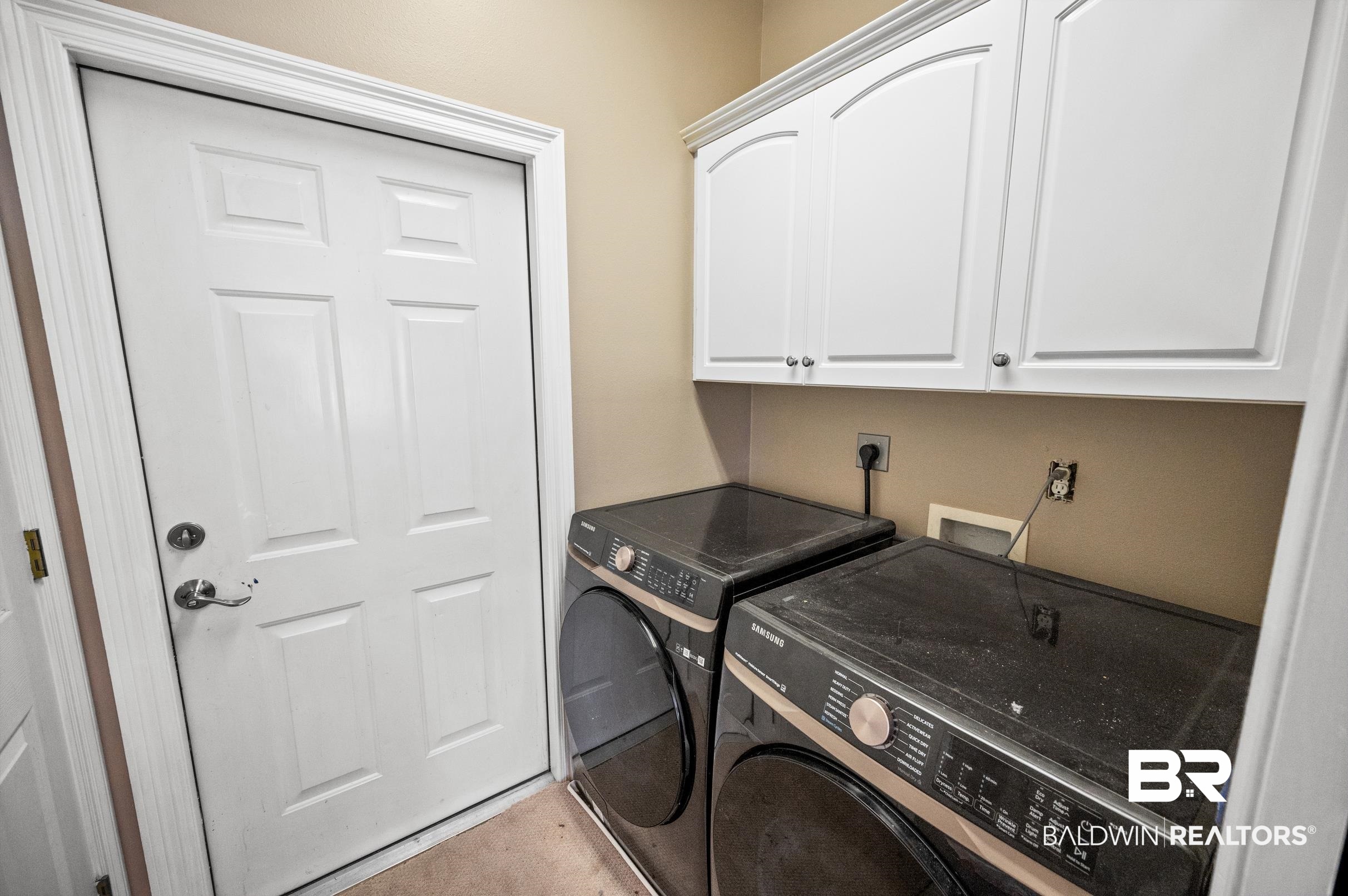 108 Natchez Trace Foley, AL 36535 - Photo 24 of 35 Laundry room featuring cabinets and washing machine and dryer