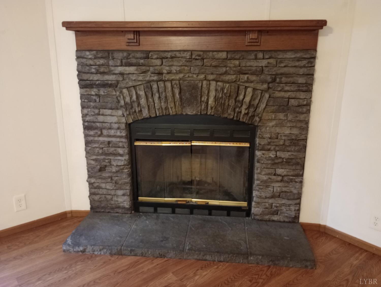 581 Red Oak School Road Rustburg, VA 24588 - Photo 5 of 17 a view of fireplace and wooden floor