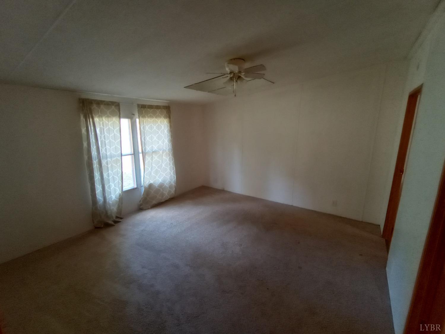 581 Red Oak School Road Rustburg, VA 24588 - Photo 10 of 17 an empty room with windows