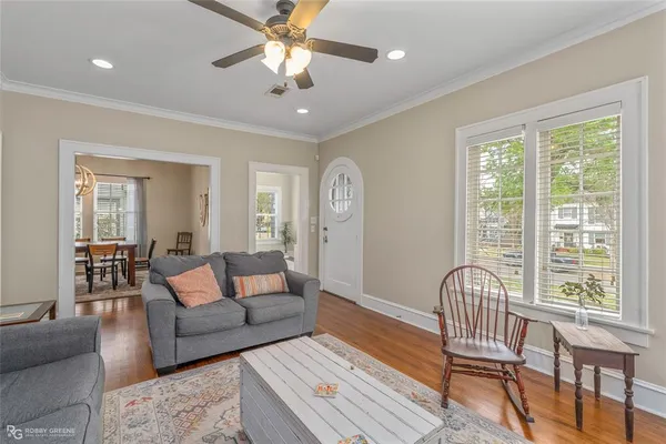 a living room with furniture and wooden floor