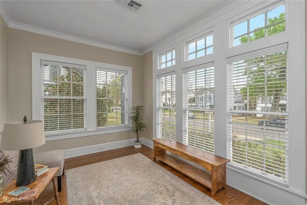 a bedroom with furniture and a large window