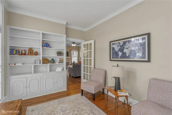 a living room with furniture and a book shelf