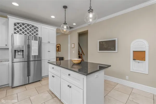 a kitchen with stainless steel appliances granite countertop a refrigerator a sink and a stove