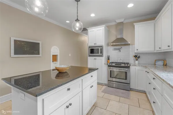 a kitchen with stainless steel appliances granite countertop a sink stove and cabinets
