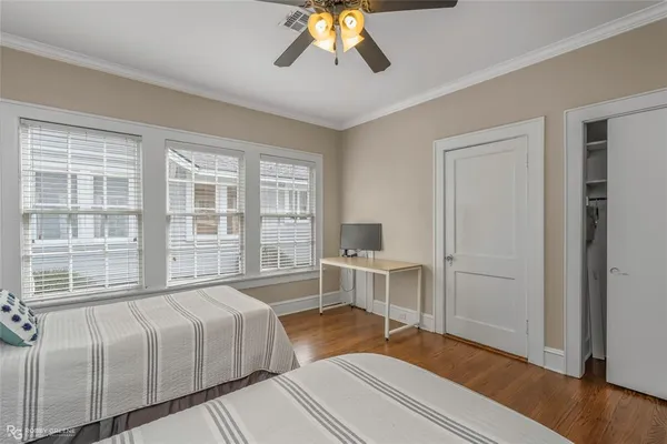a bedroom with a bed and a desk