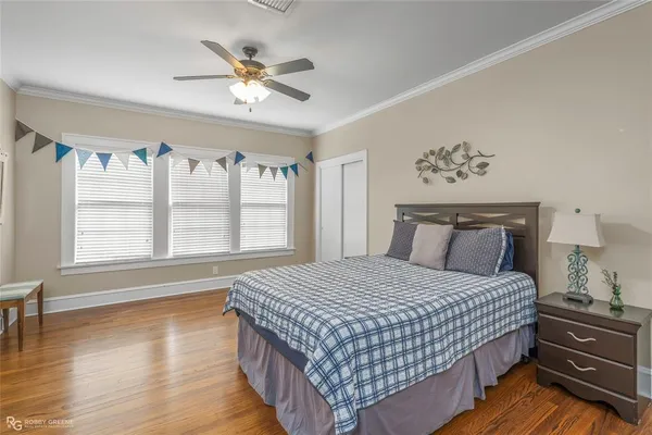 a bedroom with a large bed and a window