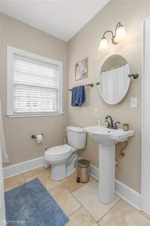 a bathroom with a sink a mirror and a toilet