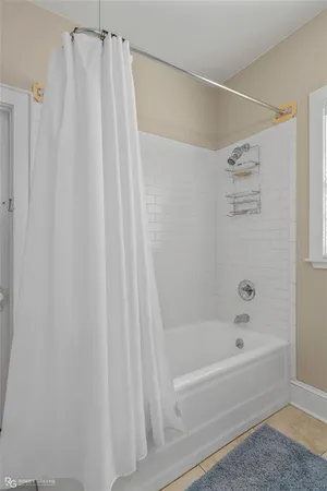 a bathroom with a shower and a bath tub