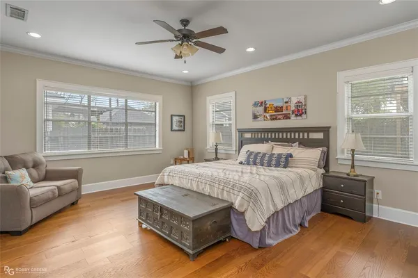 a spacious bedroom with a bed a couch and a window