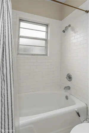 a bathroom with a bathtub and a shower