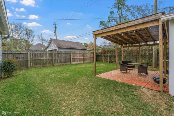 a view of a backyard with sitting area