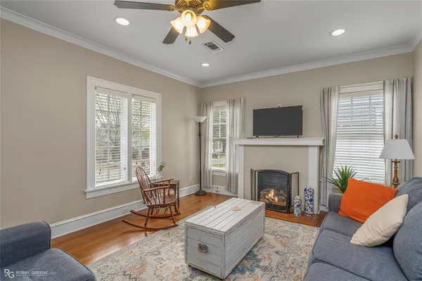 a living room with furniture and a fireplace