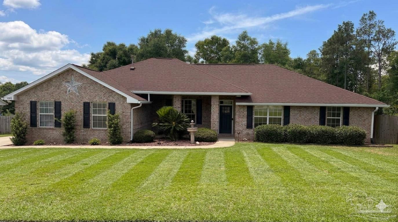 3055 Wallace Lake Road Pace, FL 32571 - Photo 1 of 33 a front view of a house with yard and green space