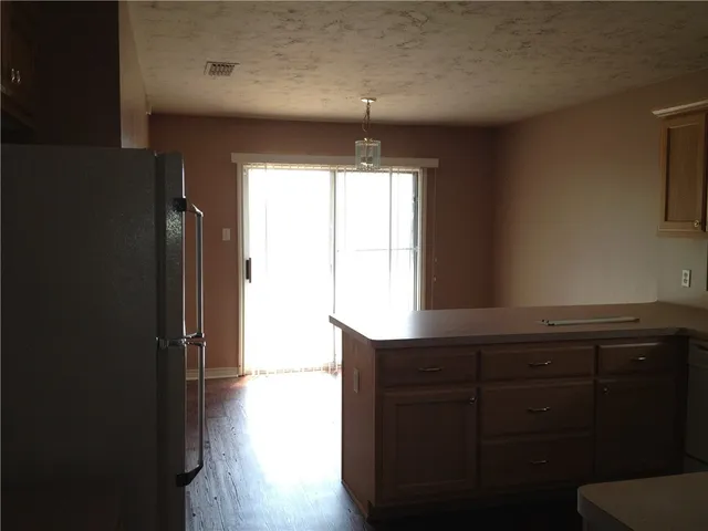 a kitchen with a window a sink and a refrigerator