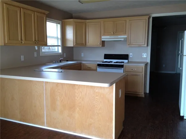 a kitchen with a refrigerator and a sink