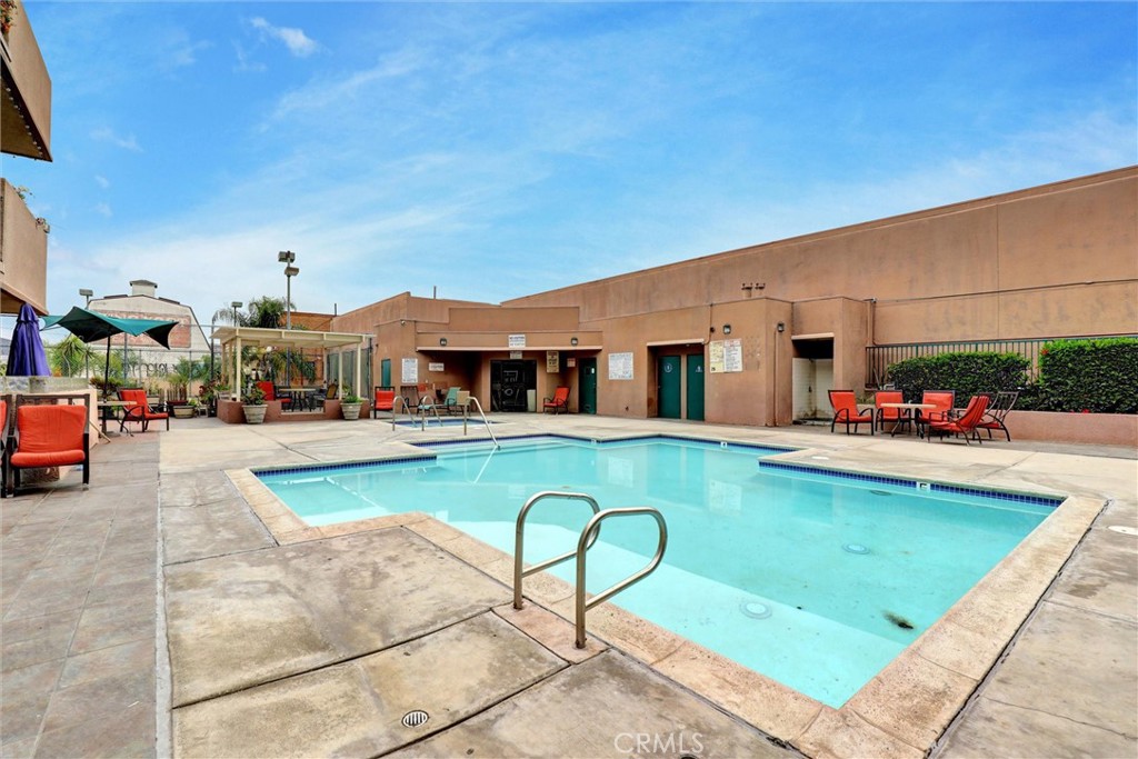 450 East 4th Street, Unit 337 Santa Ana, CA 92701 - Photo 23 of 26 a view of swimming pool with outdoor seating and house in the background