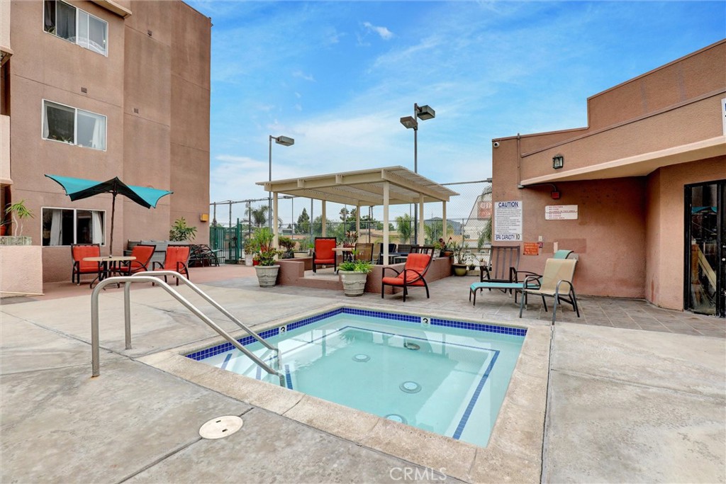 450 East 4th Street, Unit 337 Santa Ana, CA 92701 - Photo 24 of 26 a view of a patio with a table and chairs under an umbrella