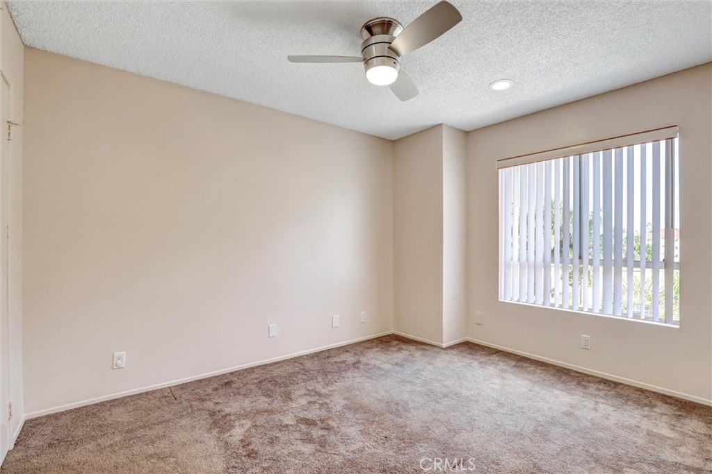 450 East 4th Street, Unit 337 Santa Ana, CA 92701 - Photo 10 of 26 an empty room with windows and ceiling fan