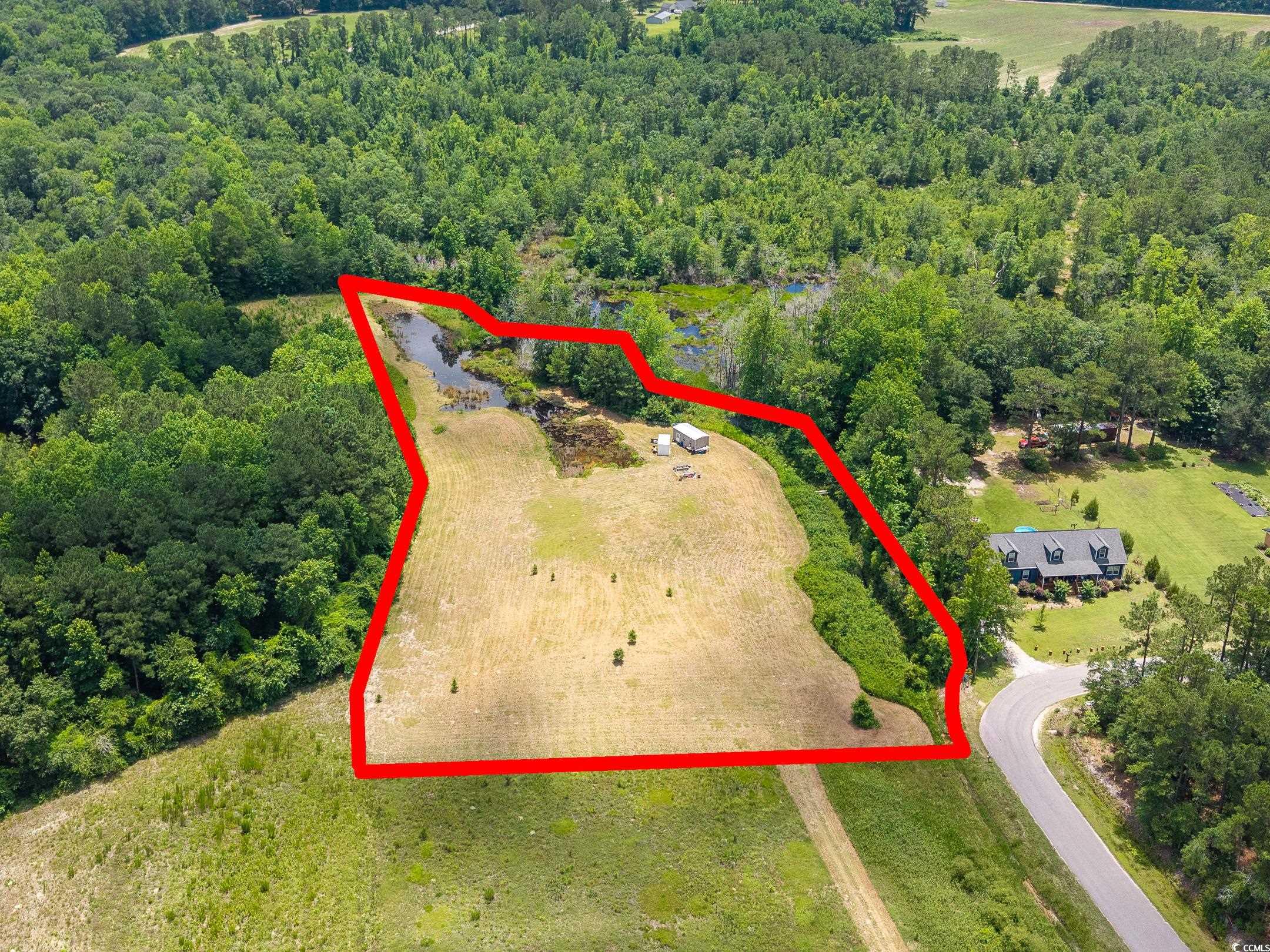 214 Allsbrook Road Loris, SC 29569 - Photo 8 of 15 Aerial view of property and surrounding area featuring a heavily wooded area and property boundaries highlighted