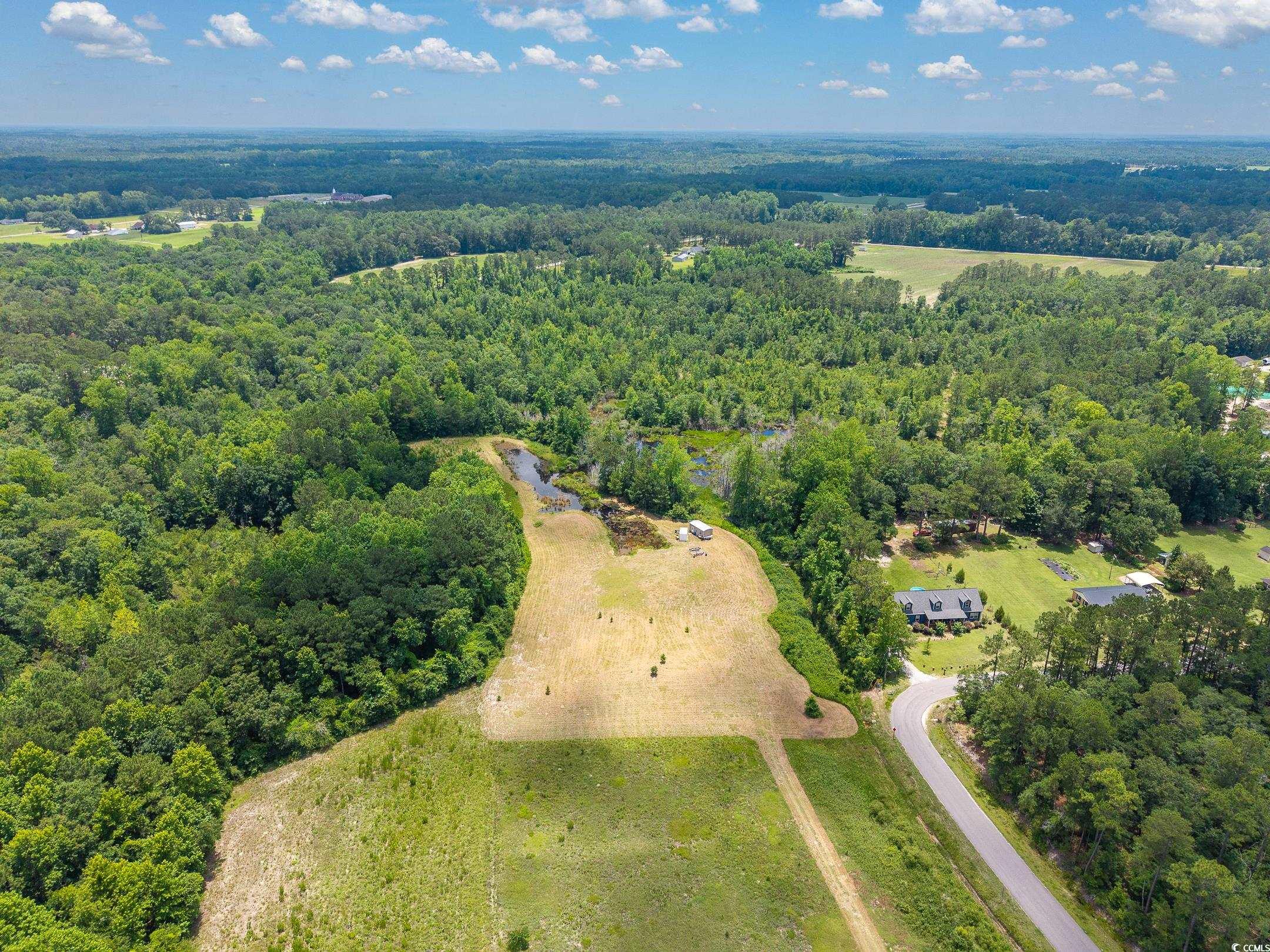 214 Allsbrook Road Loris, SC 29569 - Photo 9 of 15 Aerial view of property and surrounding area with a heavily wooded area
