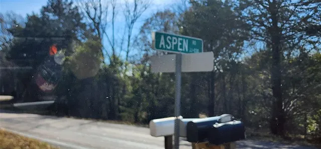 a backyard of a house with barbeque oven table and chairs