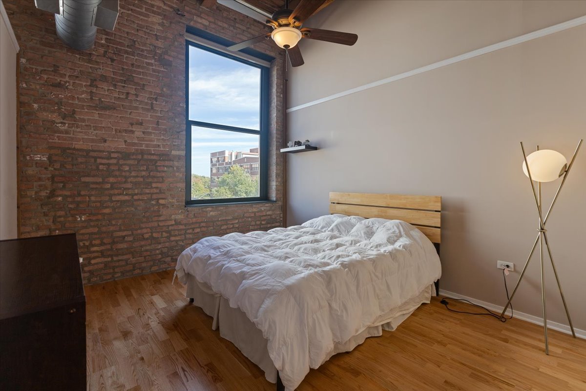 1632 South Indiana Avenue, Unit 403 Chicago, IL 60616 - Photo 12 of 23 a bedroom with a bed and a window