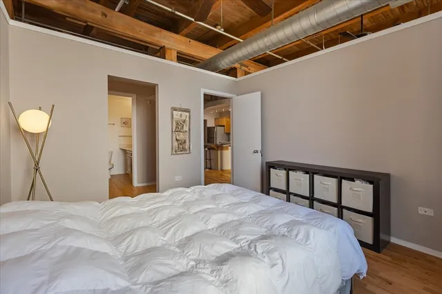 a bedroom with a bed and a large window